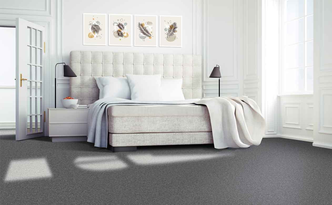 Gray carpet in white bedroom with king sized bed, nightstand lamps and modern art