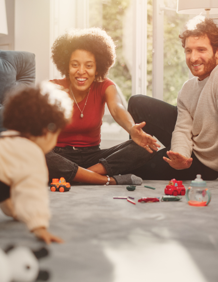 family playing on carpet in living room
